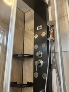 a shower with a glass door in a bathroom at King room with garden access in Raynes Park +8 photos