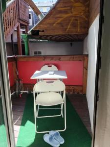 a table in the middle of a room with a green floor at BLR Apartment in Graz
