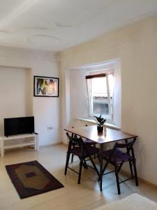 a living room with a table and a television at BLR Apartment in Graz