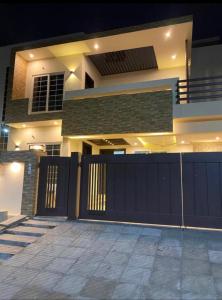 a house with a gate and a fence at Comfort Family Villa Islamabad in Islamabad