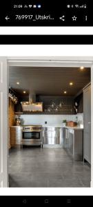 a large kitchen with stainless steel appliances at Et soverom, delt bad in Fredrikstad