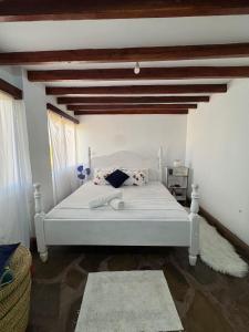 a bedroom with a white bed in a room at Mida creek front one bedroom in Watamu
