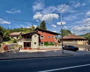 a house sitting on the side of a street at Apart Cobras Jajce in Jajce