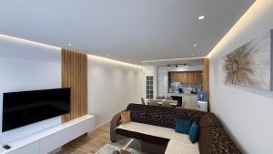a living room with a couch and a flat screen tv at Sea&Sun Living in Ulcinj
