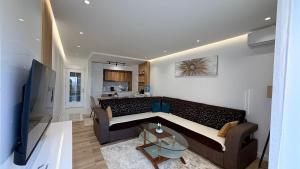 a living room with a couch and a table at Sea&Sun Living in Ulcinj