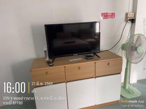 a flat screen tv sitting on top of a dresser at Ao Nang Room And Bike 10 in Ao Nang 