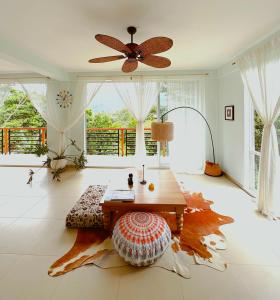 a living room with a table and a large window at Casa Li Tayrona in El Zaino
