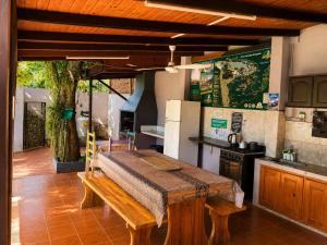 a kitchen with a wooden table in a room at Hostel & Posada Noelia in Puerto Iguazú