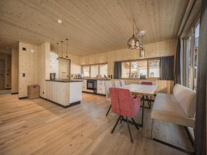 a kitchen and dining room with a table and chairs at Bichlbach Chalet with sauna in Bichlbach