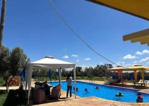 a person standing in front of a swimming pool at Propriété La Petite Ferme in Casablanca