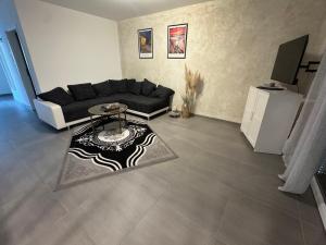 a living room with a couch and a table at Ferienwohnung Emerson 2 in Edemissen