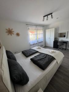 a large bed with two pillows on it in a bedroom at Ferienwohnung Emerson 2 in Edemissen