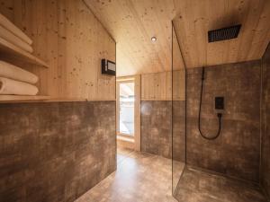 a bathroom with a shower and a glass shower stall at Your bright chalet with sauna in Bichlbach in Bichlbach