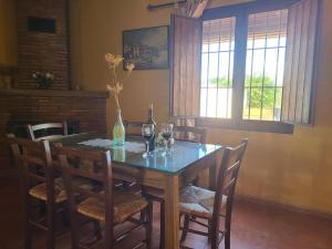 a dining room table with wine glasses and a vase at Villa in Andalusia with Private Pool in Fuentes de Cesna
