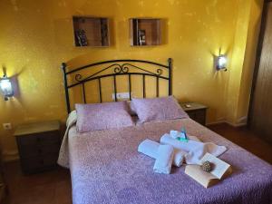 a bed with two towels and two books on it at Villa in Andalusia with Private Pool in Fuentes de Cesna