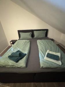 a bed with two pillows on top of it at Ferienwohnung Emerson in Edemissen