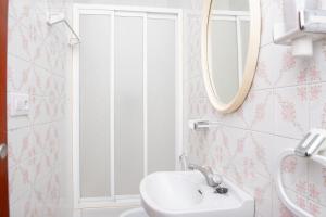 a bathroom with a sink and a mirror at Laxes do Mar in Baiona +31 photos