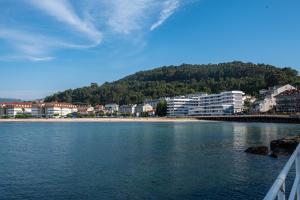 a body of water with buildings and a city at Laxes do Mar in Baiona