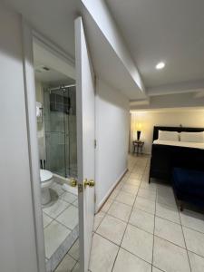 a bathroom with a toilet and a bedroom with a bed at COMFY Basement Home 2 Bdrm1Den 3Queen Beds in Washington, D.C. +25 photos