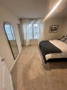 a bedroom with a bed and a large mirror at Milford House in Milford