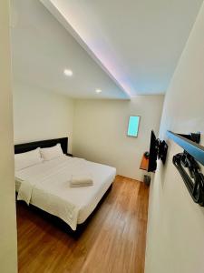 a bedroom with a bed in a room with a ceiling at Soho Tabuan Kuching in Kuching