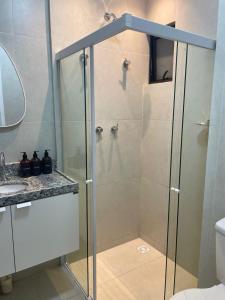 a shower with a glass door in a bathroom at White Life in Caruaru +17 photos