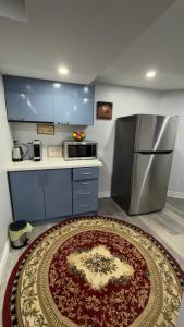 a kitchen with a refrigerator and a rug on the floor at Beautiful lake view Basment room in Brampton