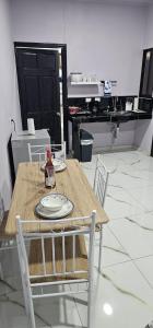 a wooden table and chairs with a plate on it at Apartment Torres in Manuel Antonio