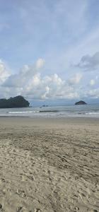 a sandy beach with waves in the ocean at Apartment Torres in Manuel Antonio +5 photos