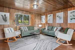 a living room with two couches and a rug at Hottub Hideaway: Firepit; Sauna; Views; Wildlife in Custer