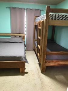 a bedroom with two bunk beds in a room at Fuga Ecolodge Casa grande in Carara