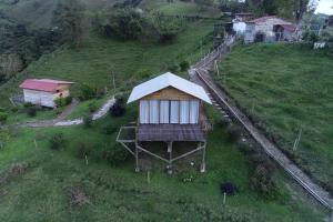an aerial view of a small house on a hill at La Alborada Glamping in Filandia
