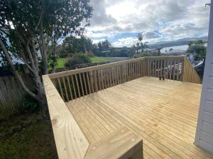 a wooden deck with a bench on a house at Mangōnui Harbour Haven in Mangonui