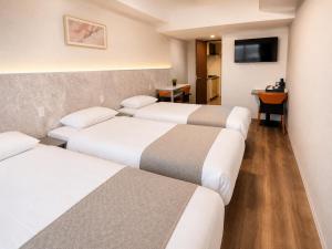 a hotel room with three beds and a television at Hotel Arashi Tengachaya No005 in Osaka +47 photos