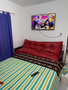 a bedroom with a bed with a video game poster on the wall at Runa Huasi in Tinogasta