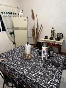 a table with a table cloth with a candle on it at Runa Huasi in Tinogasta