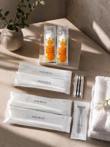 a table topped with white napkins and oranges in plastic bags at Hotel Arashi Tengachaya No005 in Osaka