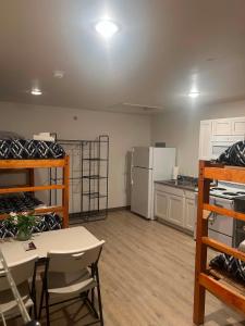 a room with a kitchen with a table and a refrigerator at Pond Studio Apartments in Seward +15 photos