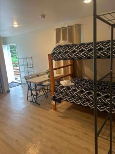 a room with two bunk beds and a table at Pond Studio Apartments in Seward