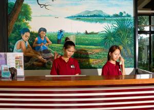 two women sitting at a table with a laptop at Tunnel Urban Retreat in Siem Reap +196 photos