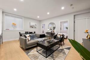 a living room with a couch and a table at The North Shore Luxe Suite in North Vancouver