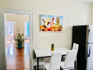 a dining room with a white table and white chairs at CaneView Properties - 3 in Irvington