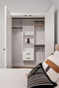 a bedroom with white cabinets and a bed at The North Shore Luxe Suite in North Vancouver +9 photos