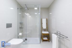 a bathroom with a shower and a toilet and a sink at Almada Story Apartments by Porto City Hosts in Porto