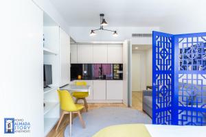 a kitchen and a living room with a yellow chair at Almada Story Apartments by Porto City Hosts in Porto
