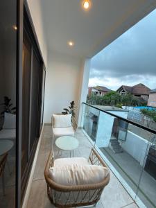 a balcony with chairs and a table and a view at Bellagio Two Bedroom with Balcony in Kwedonu