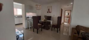 a kitchen and dining room with a table and chairs at La cubana in Santo Domingo