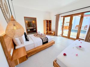 a bedroom with a bed and a view of the ocean at Yamore Villa in Gili Islands