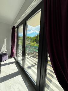 a sliding glass door with a view of a balcony at Casa din lunca 2 in Poiana Mărului