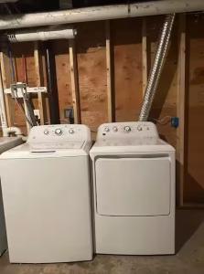 two washing machines sitting next to each other in a room at Vibrant 4BR Boston Apt - Balcony, Bathtub, TV near I-95 & Pet Friendly 903 in Boston